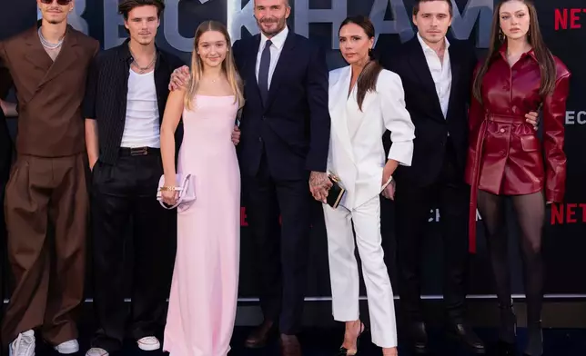 FILE - Romeo Beckham, from left, Cruz Beckham, Harper Beckham, David Beckham, Victoria Beckham, Brooklyn Beckham and Nicola Peltz Beckham appear at the premiere of the Netflix docuseries "Beckham" in London on Oct. 3, 2023. (AP Photo/Vianney Le Caer, File)