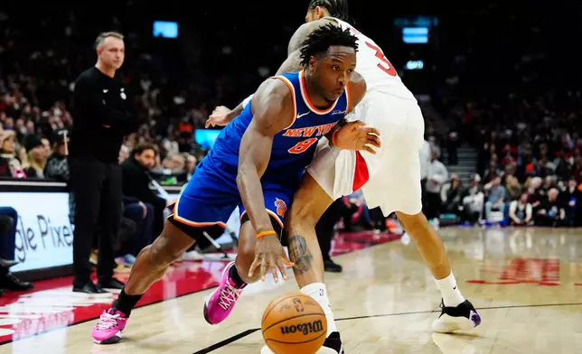 New York Knicks' Og Anunoby (8) drives past Toronto Raptors' Brandon Ingram (3) during the second half of an NBA basketball game in Toronto on Wednesday, Jan. 28, 2026. (Frank Gunn/The Canadian Press via AP)