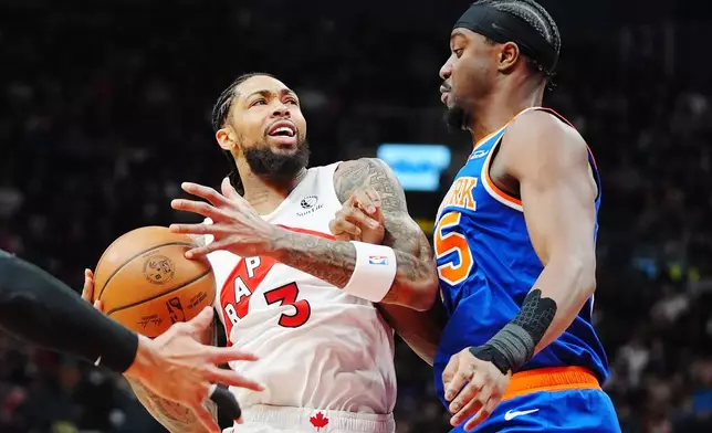 Toronto Raptors' Brandon Ingram (3) is fouled by New York Knicks' Ariel Hukporti (55) during first half NBA basketball action in Toronto on Wednesday, Jan. 28, 2026. (Frank Gunn/The Canadian Press via AP)
