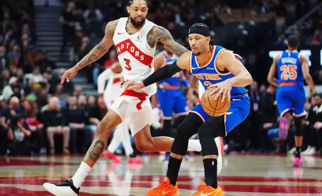 New York Knicks' Josh Hart (right) protects the ball from Toronto Raptors' Brandon Ingram (3) during first half NBA basketball action in Toronto on Wednesday, Jan. 28, 2026. (Frank Gunn/The Canadian Press via AP)
