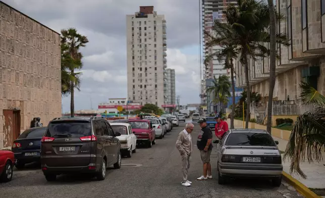 Drivers wait in line to fill up at a gas station in Havana, Cuba, Tuesday, Jan. 27, 2026. (AP Photo/Ramon Espinosa)