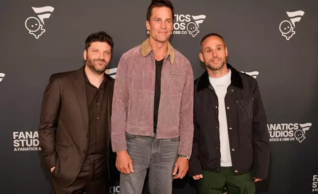 Tom Brady, center, poses with Michael D. Ratner, left, founder and CEO of OBB Media and CEO of Fanatics Studio, and Fanatics founder Michael Rubin at the launch party for Fanatics Studio, a global studio for sports entertainment, on Tuesday, Jan. 13, 2026, at the Intuit Dome in Inglewood, Calif. (AP Photo/Chris Pizzello)