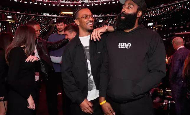 NFL quarterback Jayden Daniels, center, and NBA player James Harden mingle at the launch party for Fanatics Studio, a global studio for sports entertainment, on Tuesday, Jan. 13, 2026, at the Intuit Dome in Inglewood, Calif. (AP Photo/Chris Pizzello)