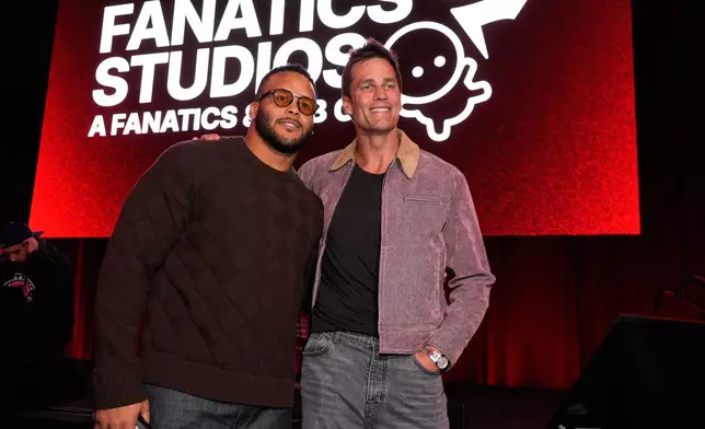 Retired NFL players Aaron Donald, left, and Tom Brady pose together at the launch party for Fanatics Studio, a global studio for sports entertainment, on Tuesday, Jan. 13, 2026, at the Intuit Dome in Inglewood, Calif. (AP Photo/Chris Pizzello)