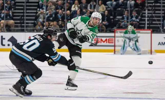 Dallas Stars defenseman Kyle Capobianco, right, moves the puck against Utah Mammoth defenseman Sean Durzi during the second period of an NHL hockey game, Thursday, Jan. 15, 2026, in Salt Lake City. (AP Photo/Melissa Majchrzak)