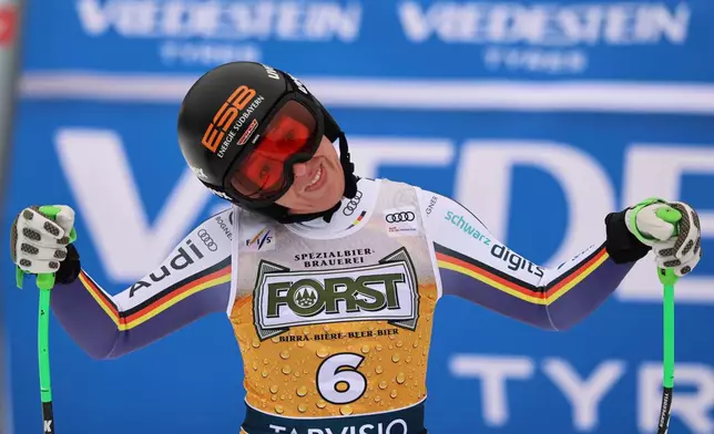 Germany's Kira Weidle Winkelmann celebrates at the finish area of an alpine ski, women's World Cup downhill, in Tarvisio, Italy, Saturday, Jan. 17, 2026. (AP Photo/Marco Trovati)