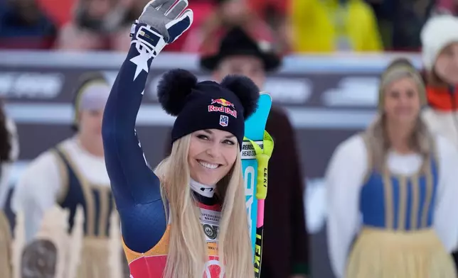 United States' Lindsey Vonn celebrates taking third place in an alpine ski, women's World Cup downhill, in Tarvisio, Italy, Saturday, Jan. 17, 2026. (AP Photo/Giovanni Auletta)