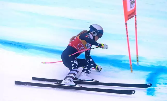 United States' Lindsey Vonn speeds down the course during an alpine ski, women's World Cup downhill, in Tarvisio, Italy, Saturday, Jan. 17, 2026. (AP Photo/Giovanni Auletta)