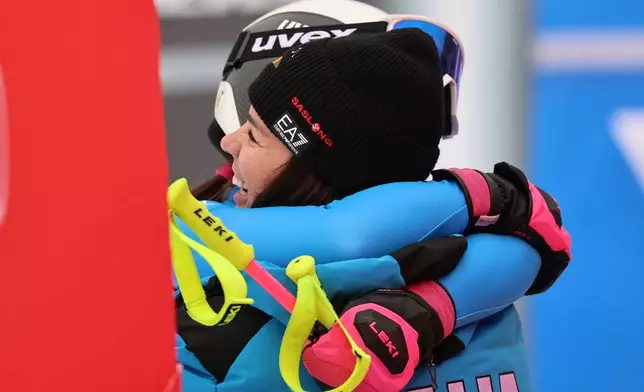 Italy's Nicol Delago right, hugs her sister Italy's Nadia Delago at the finish area of an alpine ski, women's World Cup downhill, in Tarvisio, Italy, Saturday, Jan. 17, 2026. (AP Photo/Marco Trovati)