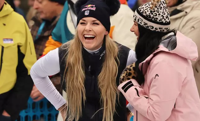 United States' Lindsey Vonn, center, smiles at the finish area of an alpine ski, women's World Cup downhill, in Tarvisio, Italy, Saturday, Jan. 17, 2026. (AP Photo/Marco Trovati)