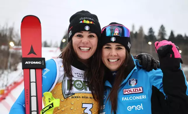 Italy's Nicol Delago right, winner of an alpine ski, women's World Cup downhill, hugs her sister Italy's Nadia Delago as they pose for a photograph, in Tarvisio, Italy, Saturday, Jan. 17, 2026. (AP Photo/Marco Trovati)