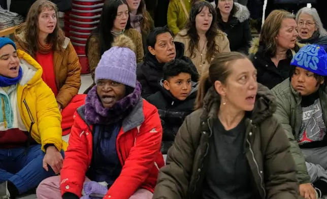 Community members and neighbors of people detained by ICE sing during a protest at a Target store, Monday, Jan. 19, 2026, in St. Paul, Minn. (AP Photo/Yuki Iwamura)