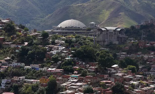 El Helicoide, top, the headquarters of Venezuela's intelligence service and detention center, stands in Caracas, Venezuela, Thursday, Jan. 8, 2026, after National Assembly President Jorge Rodriguez said the government would release a significant number of Venezuelan and foreign prisoners. (AP Photo/Matias Delacroix)