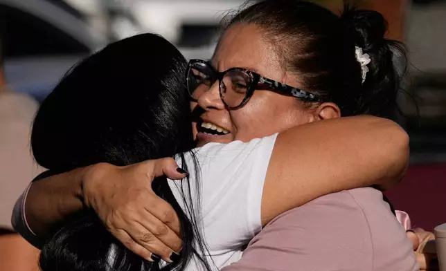 Relatives of detainee Yosnars Baduel embrace outside the Rodeo I prison in Guatire, Venezuela, Thursday, Jan. 8, 2026, after National Assembly President Jorge Rodriguez said the government would release Venezuelan and foreign prisoners. (AP Photo/Matias Delacroix)