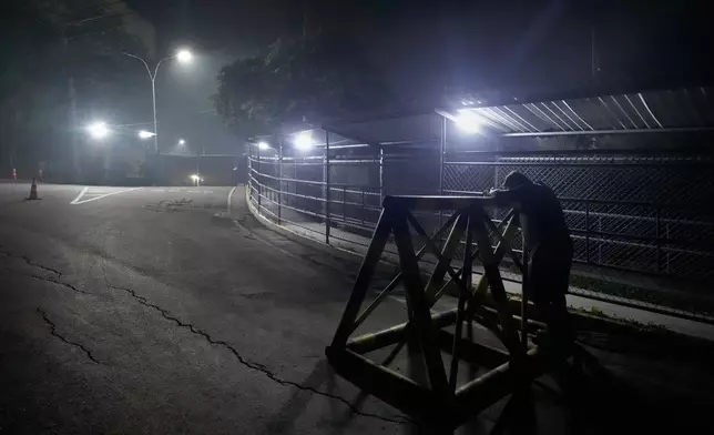 A relative of a political prisoner waits outside the Rodeo I prison in Guatire, Venezuela, Thursday, Jan. 8, 2026, after National Assembly President Jorge Rodriguez said the government would release Venezuelan and foreign prisoners. (AP Photo/Matias Delacroix)