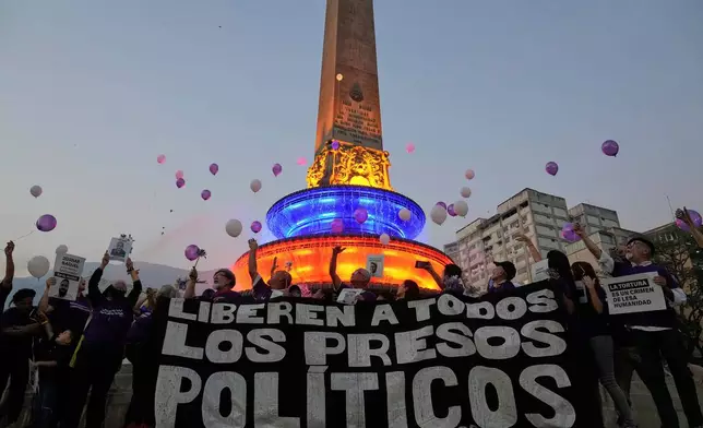 FILE - Activists and relatives of prisoners release balloons calling for the freedom of political prisoners, in Caracas, Venezuela, April 14, 2025. (AP Photo/Ariana Cubillos, File)