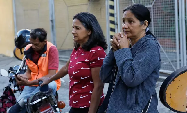 Relatives wait at Zone 7 of the Bolivarian National Police, where political detainees are held, in Caracas, Venezuela, Thursday, Jan. 8, 2026, after National Assembly President Jorge Rodriguez said the government would release Venezuelan and foreign prisoners. (AP Photo/Cristian Hernandez)