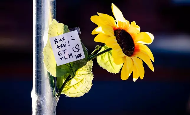 A floral tribute left near the area where a fire broke out at the Le Constellation bar and lounge during New Year's celebration, in Crans-Montana, Switzerland, Thursday, Jan. 1, 2026. (Jean-Christophe Bott/Keystone via AP)