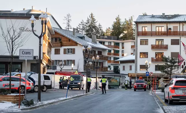 Police officers inspect the area where a fire broke out at the Le Constellation bar and lounge leaving people dead and injured, during New Year’s celebration, in Crans-Montana, Swiss Alps, Switzerland, Thursday, Jan. 1, 2026. (Alessandro della Valle/Keystone via AP)