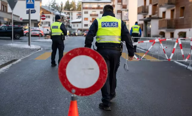 Police officers inspect the area where a fire broke out at the Le Constellation bar and lounge leaving people dead and injured, during New Year’s celebration, in Crans-Montana, Swiss Alps, Switzerland, Thursday, Jan. 1, 2026. (Alessandro della Valle/Keystone via AP)