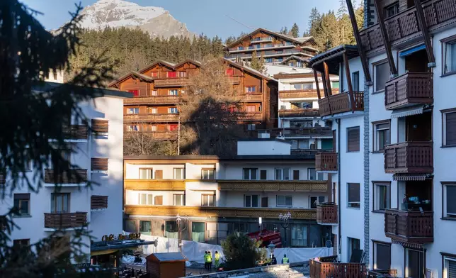 Police officers inspect the area where a fire broke out at the Le Constellation bar and lounge leaving people dead and injured, during New Year’s celebration, in Crans-Montana, Swiss Alps, Switzerland, Thursday, Jan. 1, 2026. (Alessandro della Valle/Keystone via AP)