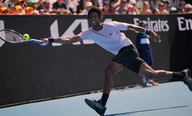 Gael Monfils of France plays a forehand return to Dane Sweeny of Australia during their first round match at the Australian Open tennis championship in Melbourne, Australia, Tuesday, Jan. 20, 2026. (AP Photo/Dita Alangkara)