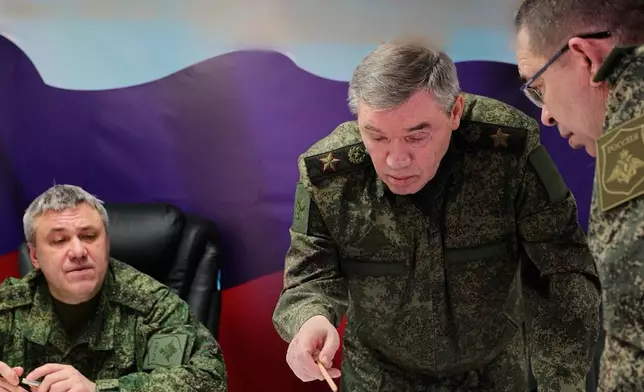 In this image made from video provided by Russian Defense Ministry Press Service on Saturday, Feb. 14, 2026, Russian Chief of General Staff Gen. Valery Gerasimov, second right, speaks while inspecting the troops involved in the fighting in Ukraine. (Russian Defense Ministry Press Service via AP)