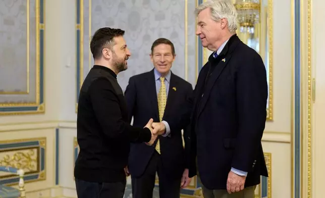 In this photo provided by the Ukrainian Presidential Press Office, Ukrainian President Volodymyr Zelenskyy, left, greets Sen. Sheldon Whitehouse D-R.I. and Sen. Richard Blumenthal, D-Ct., center, in Kyiv, Ukraine, Monday, Feb. 16, 2026. (Ukrainian Presidential Press Office via AP)