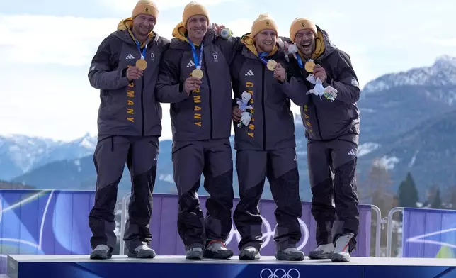 Germany's gold medalists Johannes Lochner, Thorsten Margis, Jorn Wenzel and Georg Fleischauer pose with their medals after the four man bobsled competition at the 2026 Winter Olympics, in Cortina d'Ampezzo, Italy, Sunday, Feb. 22, 2026.(AP Photo/Alessandra Tarantino)