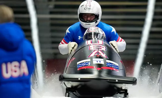 United States' Kristopher Horn, Caleb Furnell, Hunter Powell and Carsten Vissering arrive at the finish during a four man bobsled run at the 2026 Winter Olympics, in Cortina d'Ampezzo, Italy, Sunday, Feb. 22, 2026. (AP Photo/Aijaz Rahi)
