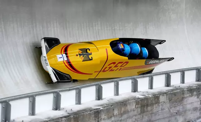 Germany's Johannes Lochner, left, Thorsten Margis, Jorn Wenzel and Georg Fleischauer slide down the track during a four man bobsled run at the 2026 Winter Olympics, in Cortina d'Ampezzo, Italy, Sunday, Feb. 22, 2026. (AP Photo/Alessandra Tarantino)