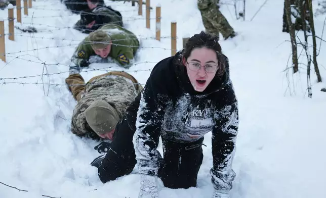 Participants of the tactical and medical courses run by the 3rd Assault Brigade demonstrate their skills in a final exam for civilians in Kyiv regional center for preparing the population for national resistance, Ukraine, Sunday, Feb. 8, 2026. (AP Photo/Sergei Grits)