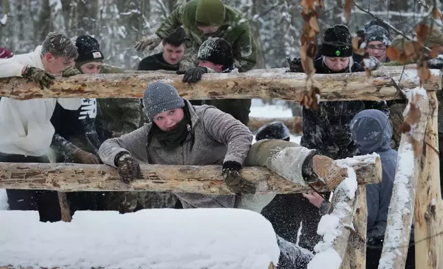 Participants of the tactical and medical courses run by the 3rd Assault Brigade demonstrate their skills in a final exam for civilians in Kyiv regional center for preparing the population for national resistance, Ukraine, Sunday, Feb. 8, 2026. (AP Photo/Sergei Grits)