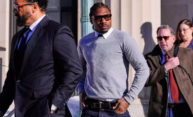 New England Patriots wide receiver Stefon Diggs leaves Norfolk County District Court after his arraignment on felony strangulation and a misdemeanor assault charges, Friday, Feb. 13, 2026, in Dedham, Mass. (AP Photo/Charles Krupa)