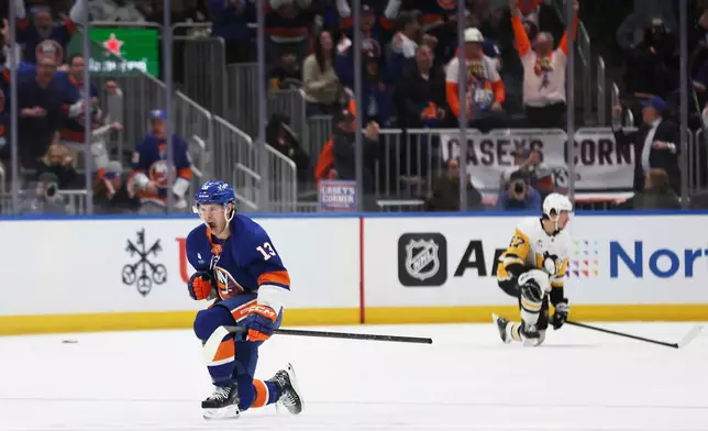 New York Islanders center Mathew Barzal (13) celebrates his goal during the third period of an NHL hockey game against the Pittsburgh Penguins, Tuesday, Feb. 3, 2026, in Elmont, N.Y. (AP Photo/Heather Khalifa)