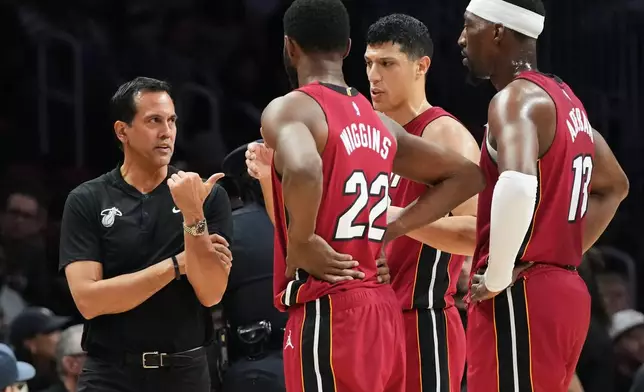 Miami Heat head coach Erik Spoelstra talk to players during a time out during the first half of an NBA basketball game against the Utah Jazz Monday, Feb. 9, 2026, in Miami. (AP Photo/Marta Lavandier)