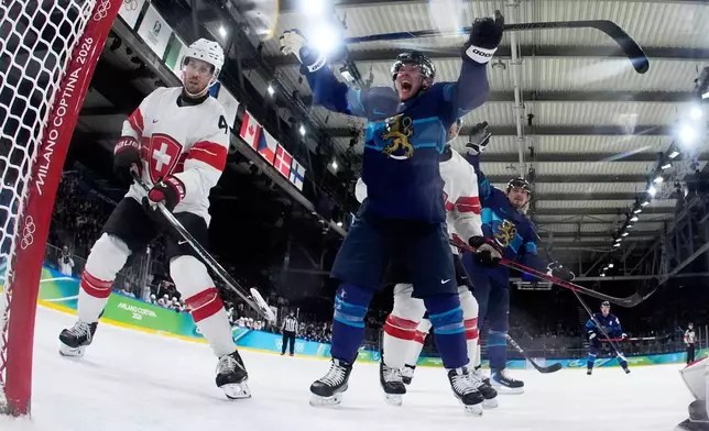 Finland's Artturi Lehkonen (62) celebrates after scoring his side's second goal during a men's ice hockey quarterfinal game between Finland and Switzerland at the 2026 Winter Olympics, in Milan, Italy, Wednesday, Feb. 18, 2026. (AP Photo/Petr David Josek, Pool)