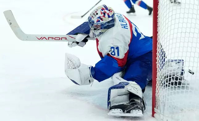 Slovakia's Samuel Hlavaj (31) fails to save a shot by Germany's Frederik Tiffels who's scored his side's second goal during a men's ice hockey quarterfinal game between Slovakia and Germany at the 2026 Winter Olympics, in Milan, Italy, Wednesday, Feb. 18, 2026. (AP Photo/Petr David Josek)