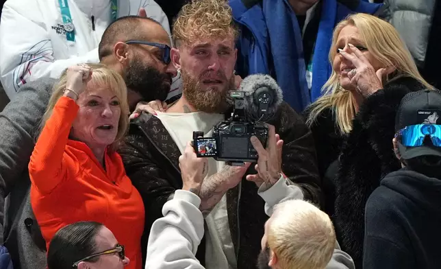 Jake Paul of the U.S., center, cries after his fiancé Jutta Leerdam of the Netherlands won the gold medal in the women's 1,000 meters speedskating race at the 2026 Winter Olympics, in Milan, Italy, Monday, Feb. 9, 2026. (AP Photo/Antonio Calanni)