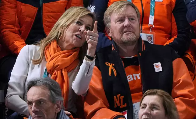 Dutch King Willem-Alexander listen to Queen Maxima as they watch the women's 1,000 meters speedskating race at the 2026 Winter Olympics, in Milan, Italy, Monday, Feb. 9, 2026. (AP Photo/Antonio Calanni)