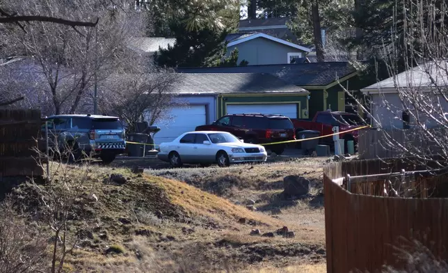 Law enforcement respond to aneighborhood in Flagstaff, Ariz. ,where police say a man opened fire on officers on Thursday, Feb. 5, 2026. (AP Photo/Cheyanne Mumphrey)