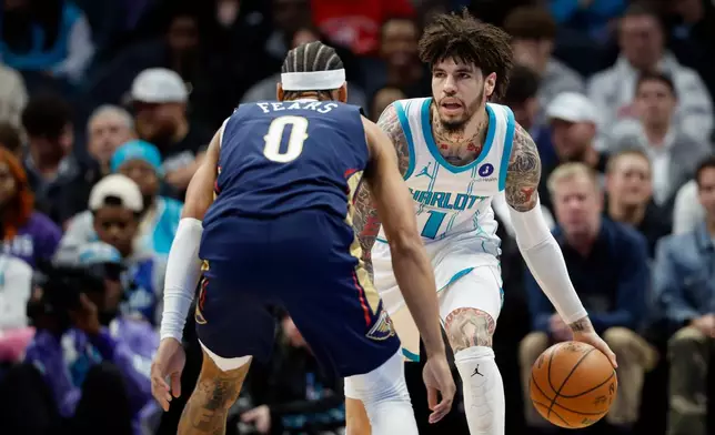 Charlotte Hornets guard LaMelo Ball (1) brings the ball upcourt against New Orleans Pelicans guard Jeremiah Fears (0) during the first half of an NBA basketball game in Charlotte, N.C., Monday, Feb. 2, 2026. (AP Photo/Nell Redmond)
