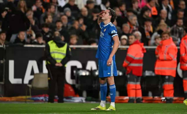 Real Madrid's Alvaro Carreras celebrates after scoring the opening goal during the Spanish La Liga soccer match between Valencia and Real Madrid in Valencia, Spain, Sunday, Feb. 8, 2026. (AP Photo/Francisco Macia)