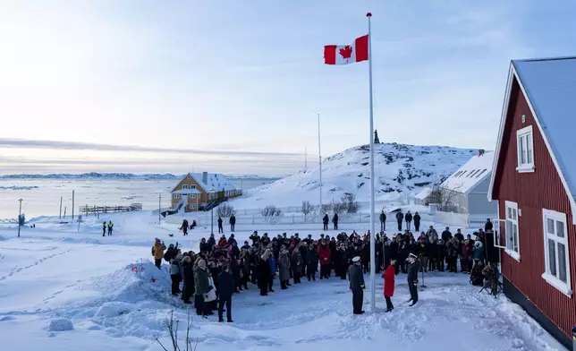 Foreign Affairs Minister Anita Anand, foreground center, helps raise the Canadian flag at the new Canadian consulate in Nuuk, Greenland, on Friday, Feb. 6, 2026. (Christinne Muschi/The Canadian Press via AP)