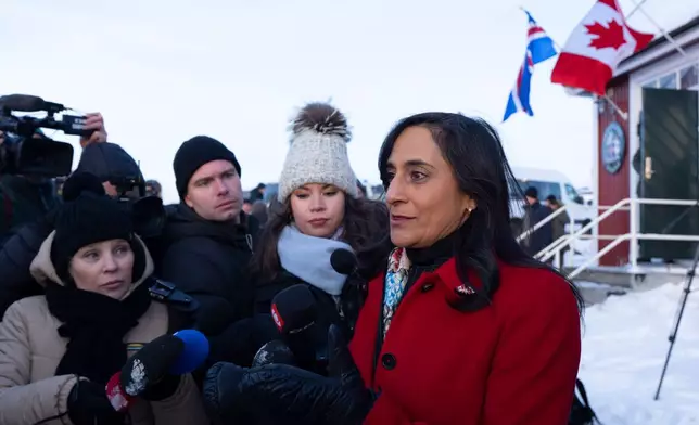Foreign Affairs Minister Anita Anand, right, speaks to the media following the flag raising at the new Canadian consulate in Nuuk, Greenland, on Friday, Feb. 6, 2026. (Christinne Muschi/The Canadian Press via AP)