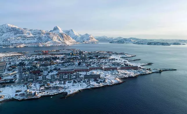 Houses are seen near the coast of a sea inlet of Nuuk, Greenland, on Sunday, Jan. 25, 2026. (AP Photo/Evgeniy Maloletka)