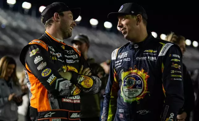Chase Briscoe and Kyle Busch, from left, speak during NASCAR Daytona 500 qualifying, Wednesday, Feb. 11, 2026, in Daytona, Fla. (AP Photo/Mike Stewart)