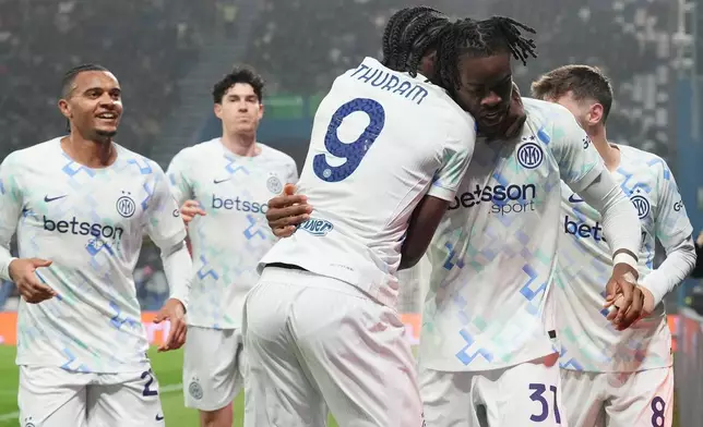 Inter Milan's Yann Bisseck, foreground right, celebrates with teammates after scoring their side's first goal of the game during the Serie A soccer match between Sassuolo and Inter in Milan, Italy, Sunday, Feb. 8, 2026. (Spada/LaPresse via AP)