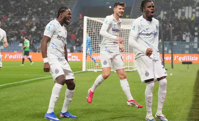 Inter Milan's Yann Bisseck, right, celebrates after scoring their side's first goal of the game during the Serie A soccer match between Sassuolo and Inter in Milan, Italy, Sunday, Feb. 8, 2026. (Spada/LaPresse via AP)
