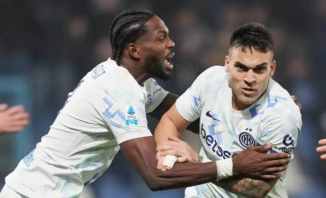 Inter Milan's Lautaro Martinez, right, celebrates with teammate Marcus Thuram after scoring their side's third goal of the game during the Serie A soccer match between Sassuolo and Inter in Milan, Italy, Sunday, Feb. 8, 2026. (Spada/LaPresse via AP)